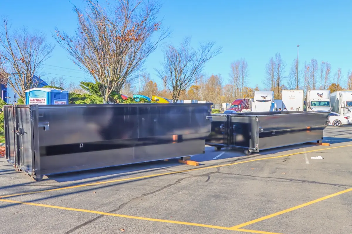 Professional dumpster rental service with roll-off container on residential driveway in O'Hara
